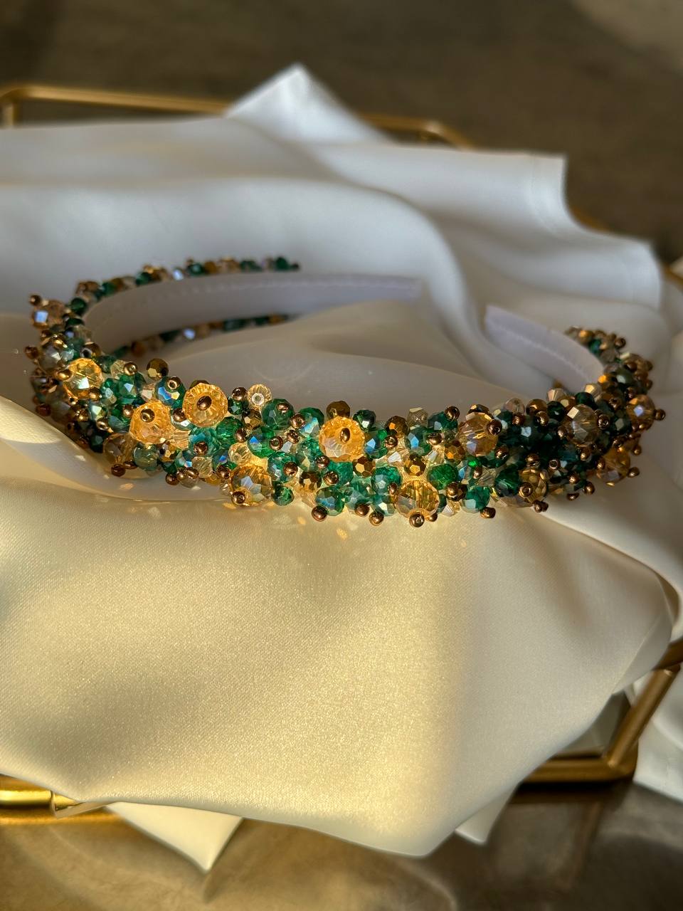 A beaded headband with green and gold floral - Victoria's Accessories